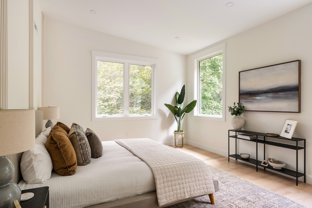 76 Harding Street Newton, MA 02465 - Photo 14 of 27 a bedroom with a bed a mirror and a window