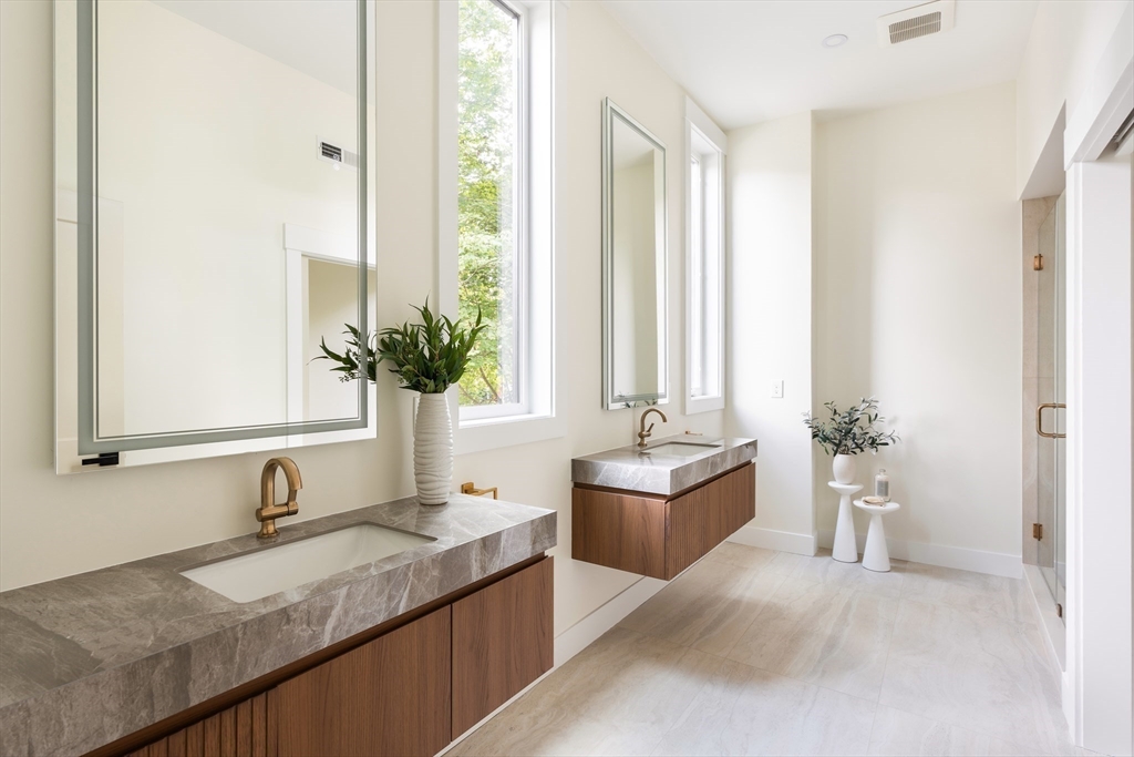 76 Harding Street Newton, MA 02465 - Photo 15 of 27 a spacious bathroom with a granite countertop tub and a sink