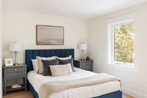 a bedroom with bed and window