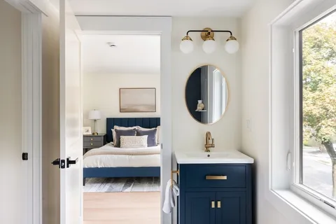 a bedroom with a bed and a mirror