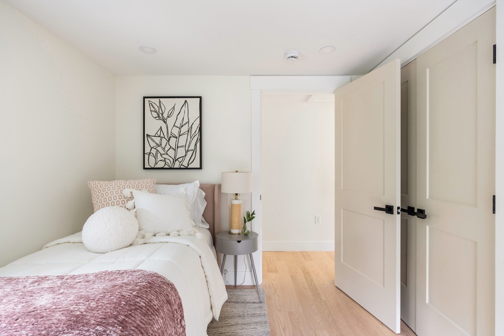 76 Harding Street Newton, MA 02465 - Photo 20 of 27 a bedroom with a bed and a painting on the wall