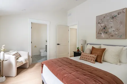 a bedroom with a bed and a couch