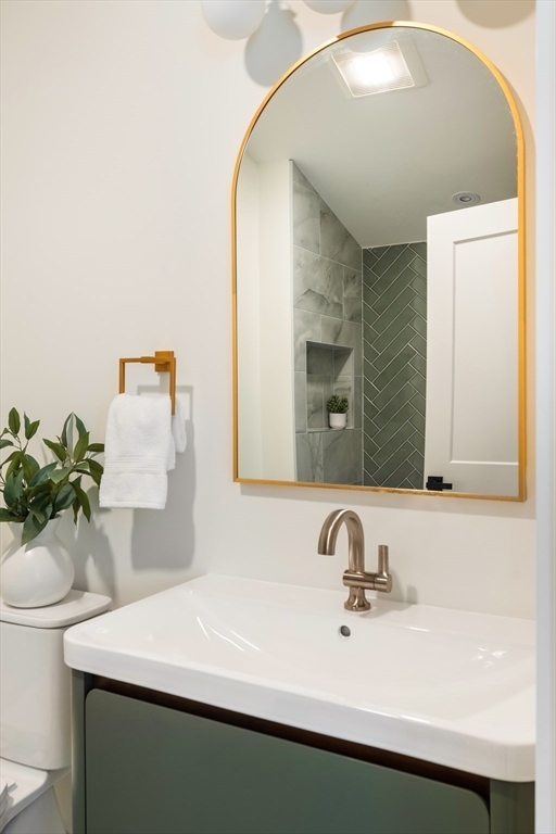 76 Harding Street Newton, MA 02465 - Photo 22 of 27 a bathroom with a sink and a mirror