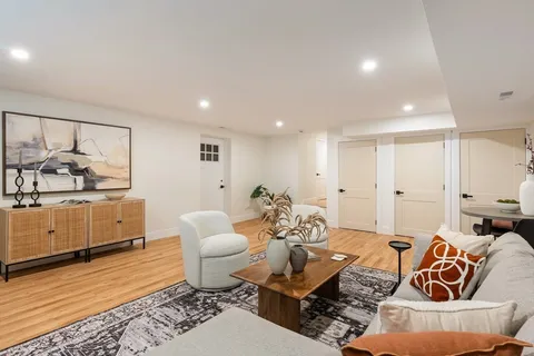 a living room with furniture and view of kitchen