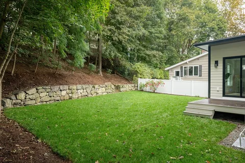 a view of a house with backyard and a garden