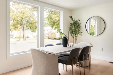 a view of a dining room with furniture window and wooden floor