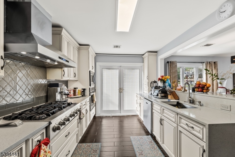 231 Starmond Avenue Clifton, NJ 07013 - Photo 11 of 32 a kitchen with stove and cabinets