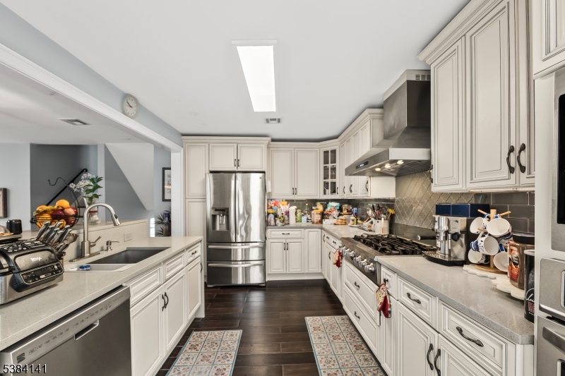 231 Starmond Avenue Clifton, NJ 07013 - Photo 12 of 32 a kitchen with refrigerator a stove and cabinets