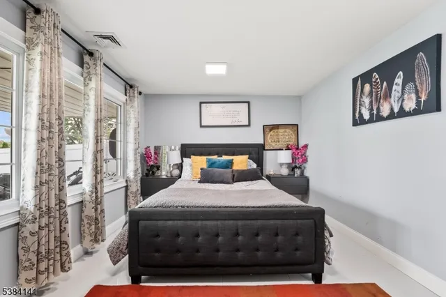 a bedroom with a bed chair and a fireplace