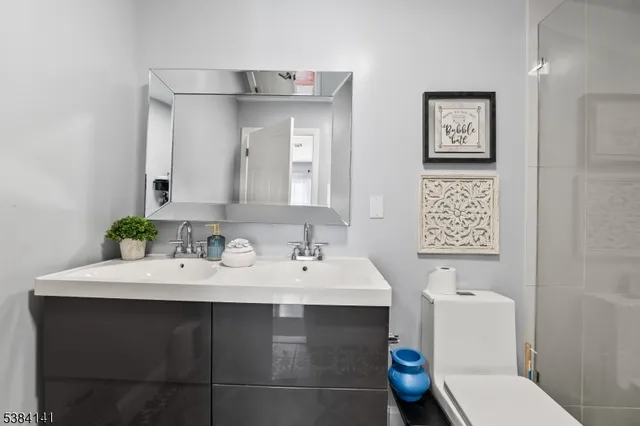 a bathroom with a sink toilet and shower