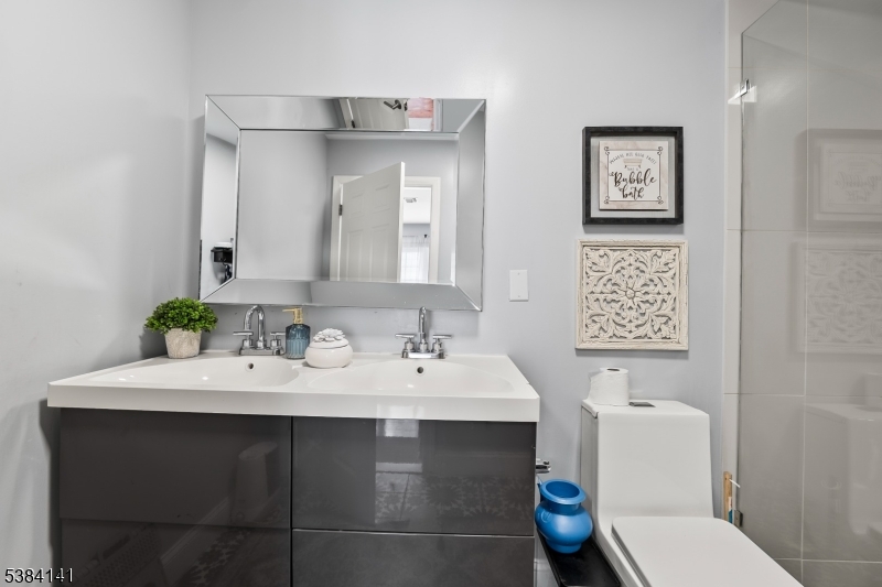 231 Starmond Avenue Clifton, NJ 07013 - Photo 19 of 32 a bathroom with a sink toilet and a mirror