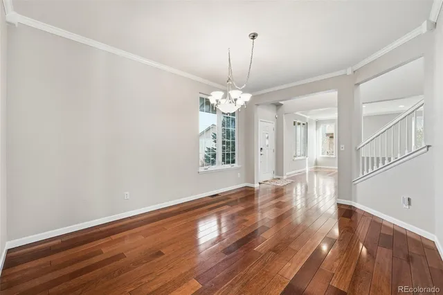 a view of a room with wooden floor chandelier and entryway