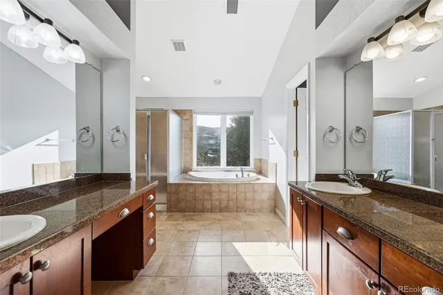 a spacious bathroom with a tub and a shower