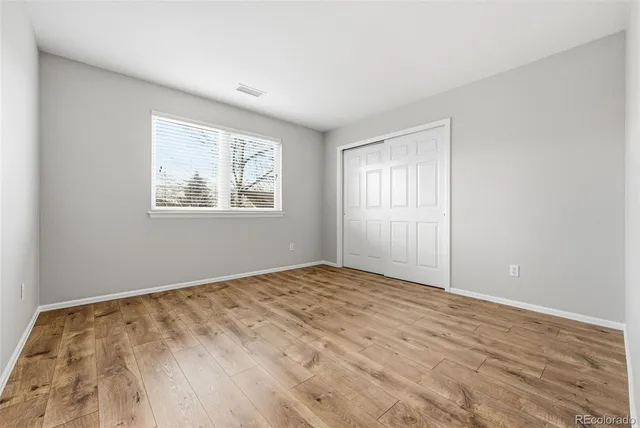 a bathroom with a double vanity sink a toilet and shower