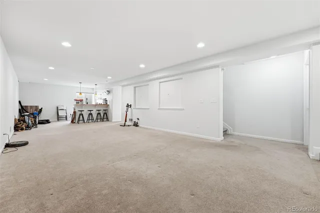 a spacious bathroom with a granite countertop sink toilet and shower