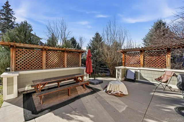 a view of a house with backyard and sitting area