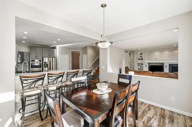 a dining room with a table chairs and kitchen view