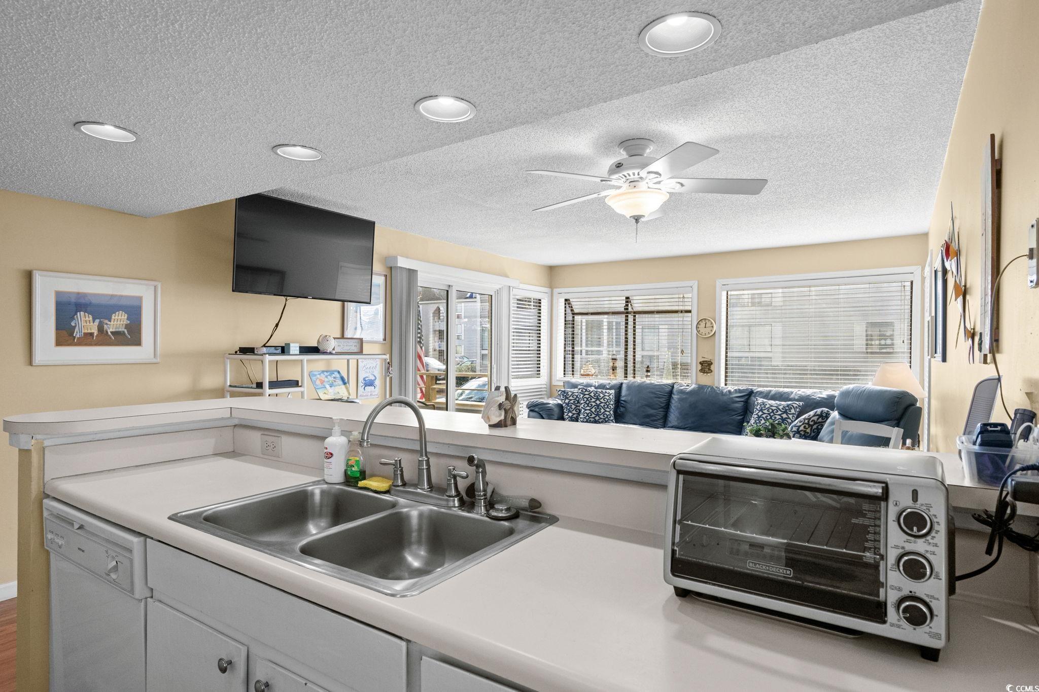 351 Lake Arrowhead Road, Unit 20179 Myrtle Beach, SC 29572 - Photo 40 of 40 Kitchen featuring light countertops, open floor plan, dishwasher, a textured ceiling, and ceiling fan