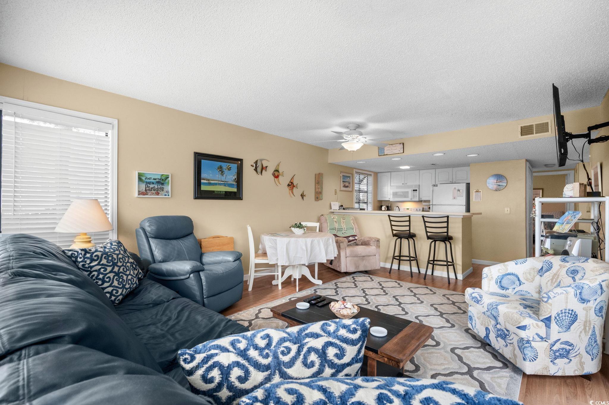 351 Lake Arrowhead Road, Unit 20179 Myrtle Beach, SC 29572 - Photo 16 of 40 Living room featuring wood finished floors, a textured ceiling, and a ceiling fan