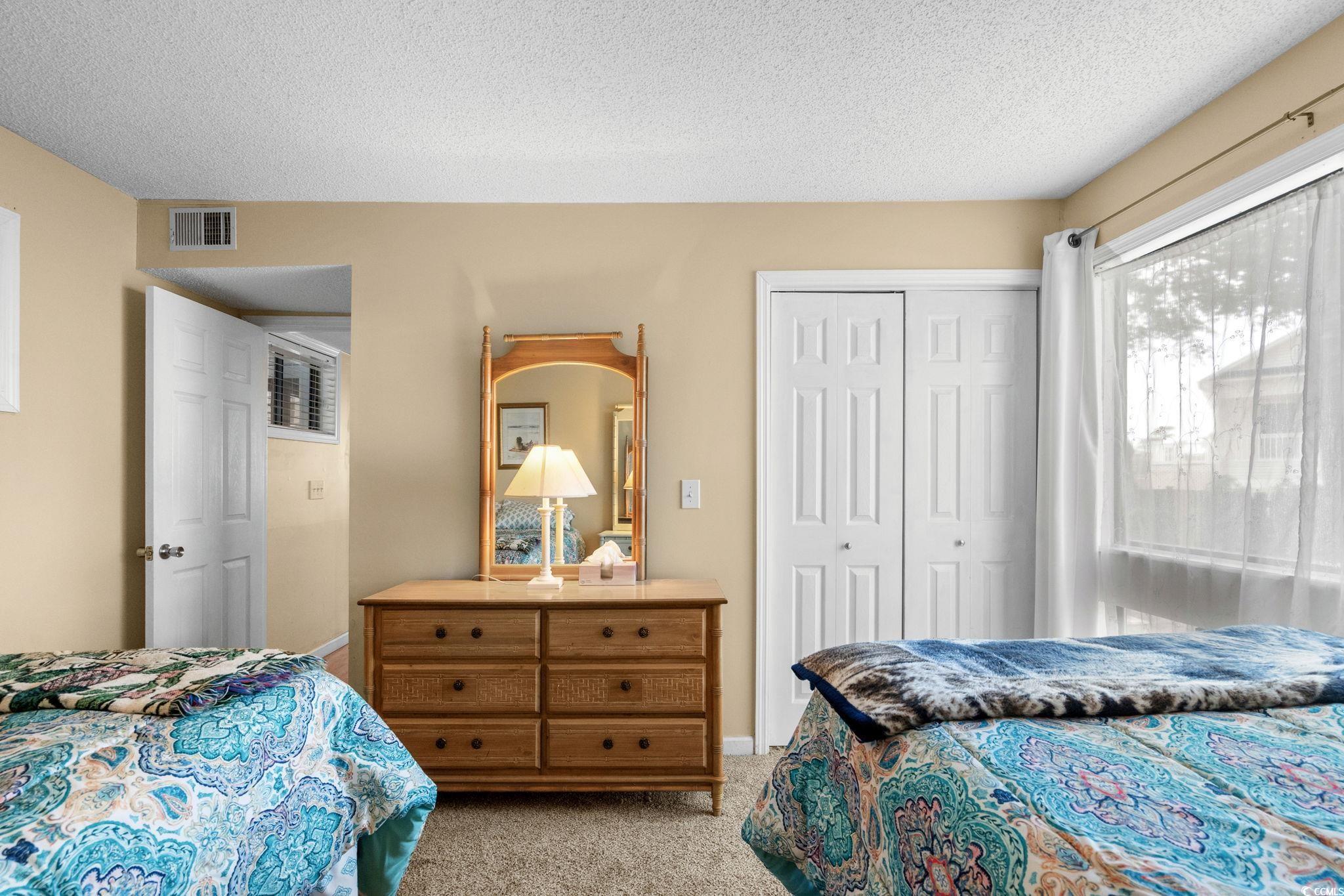 351 Lake Arrowhead Road, Unit 20179 Myrtle Beach, SC 29572 - Photo 23 of 40 Bedroom featuring light colored carpet, a textured ceiling, and a closet