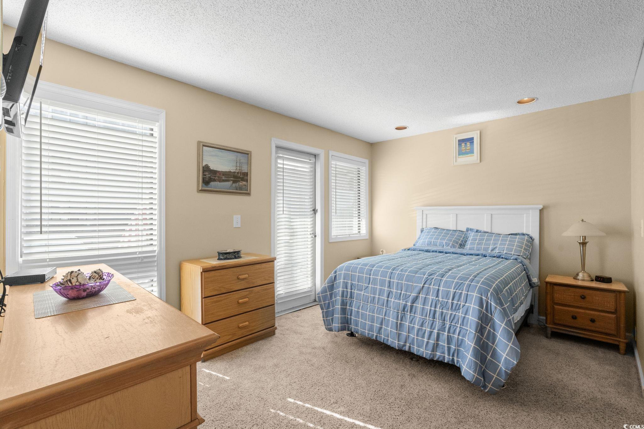 351 Lake Arrowhead Road, Unit 20179 Myrtle Beach, SC 29572 - Photo 9 of 40 Bedroom featuring a textured ceiling and light colored carpet