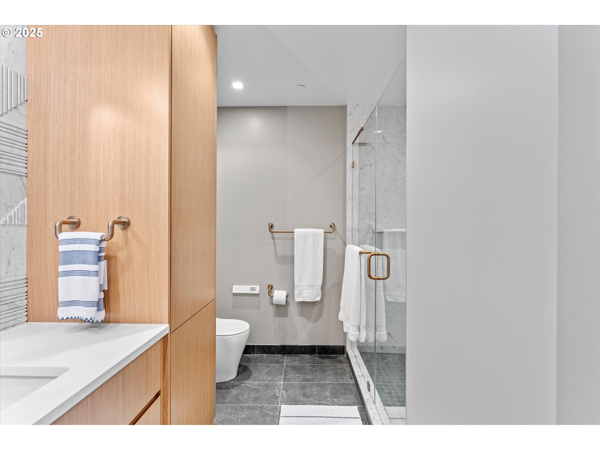 590 Waterfront Way, Unit 700 Vancouver, WA 98660 - Photo 11 of 35 a bathroom with a sink a toilet a shower and a window