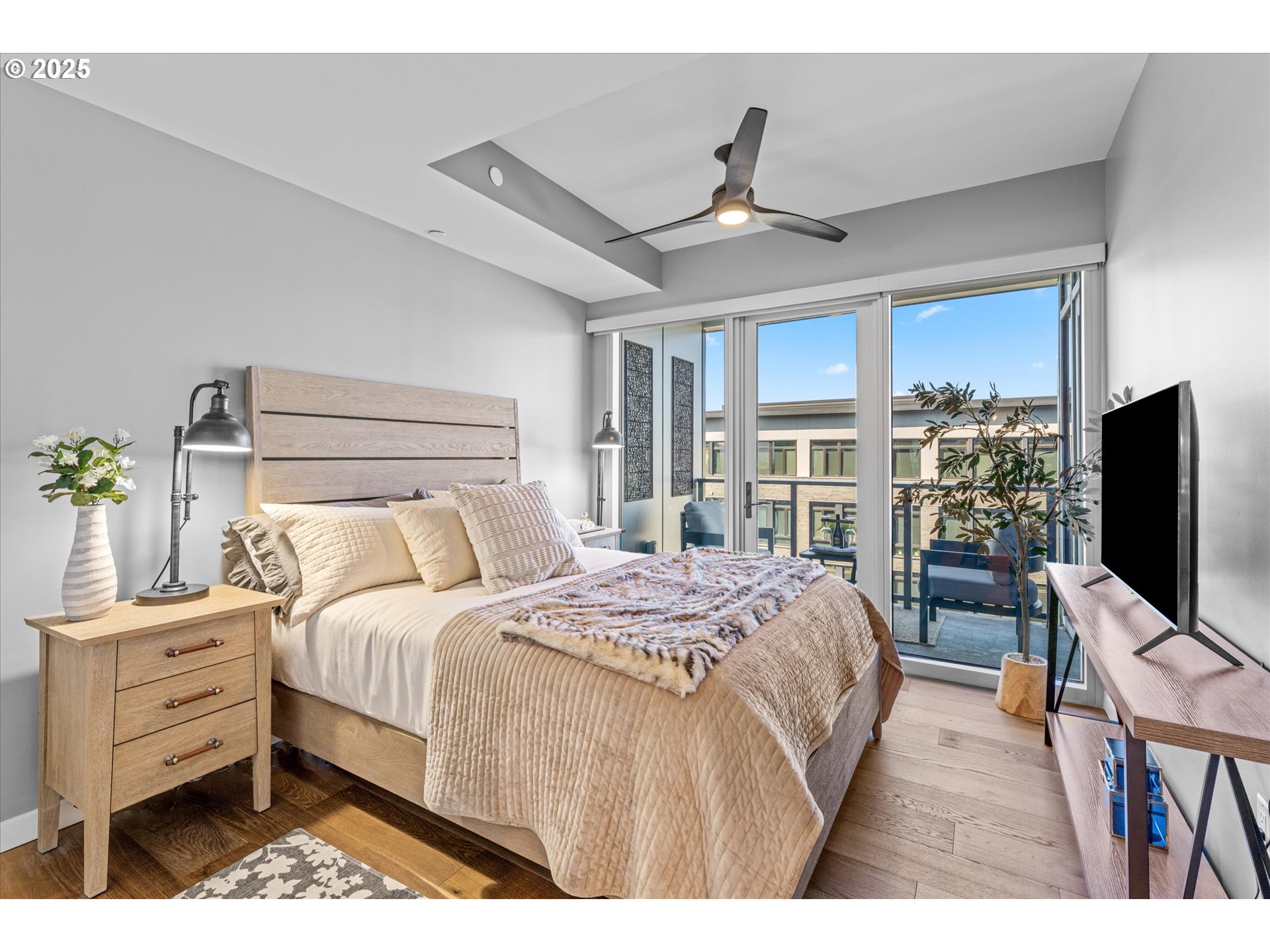 590 Waterfront Way, Unit 700 Vancouver, WA 98660 - Photo 13 of 35 a bedroom with a bed and a flat tv screen on dresser