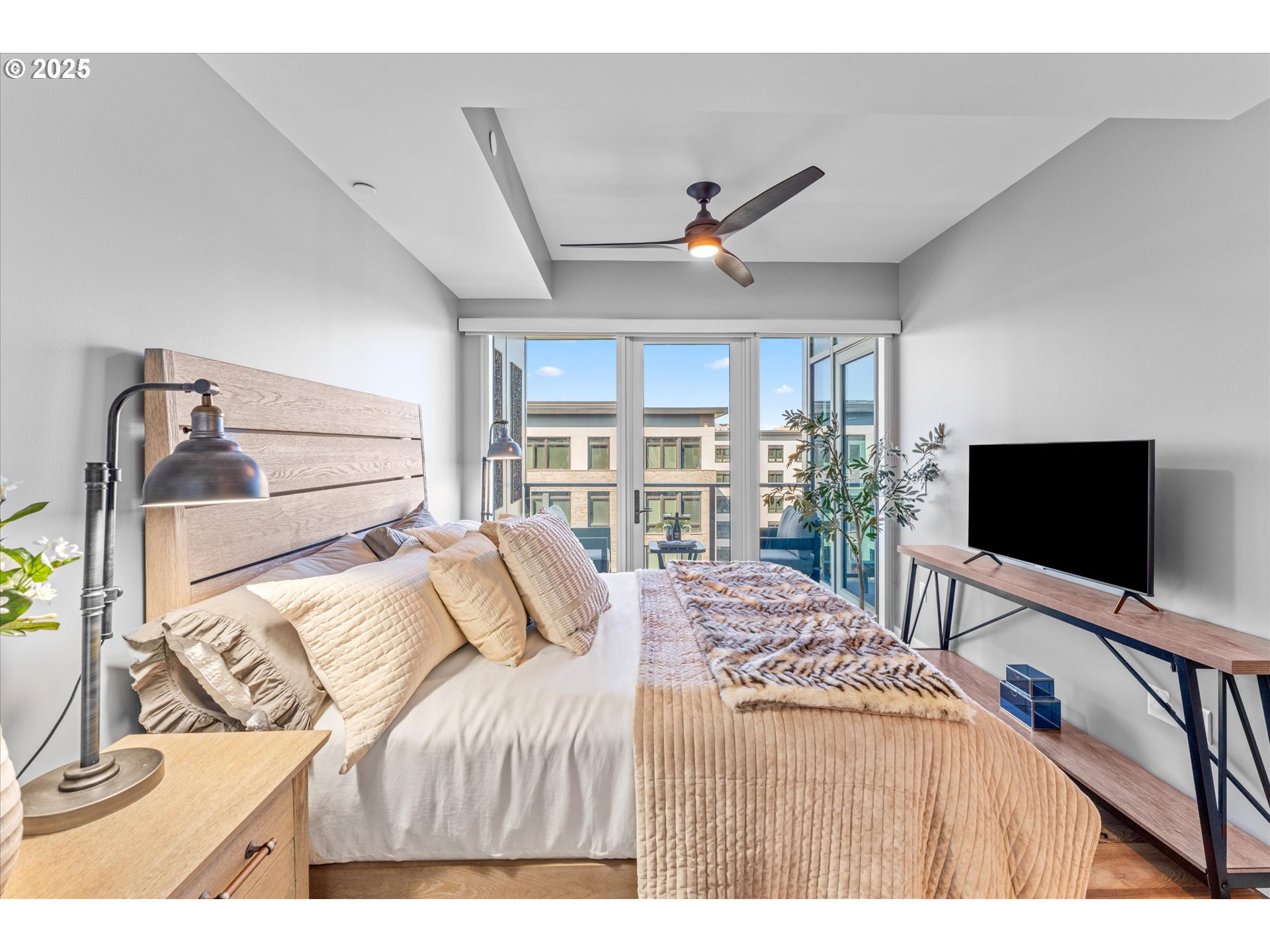 590 Waterfront Way, Unit 700 Vancouver, WA 98660 - Photo 14 of 35 a bedroom with a bed and a flat tv screen on the dresser
