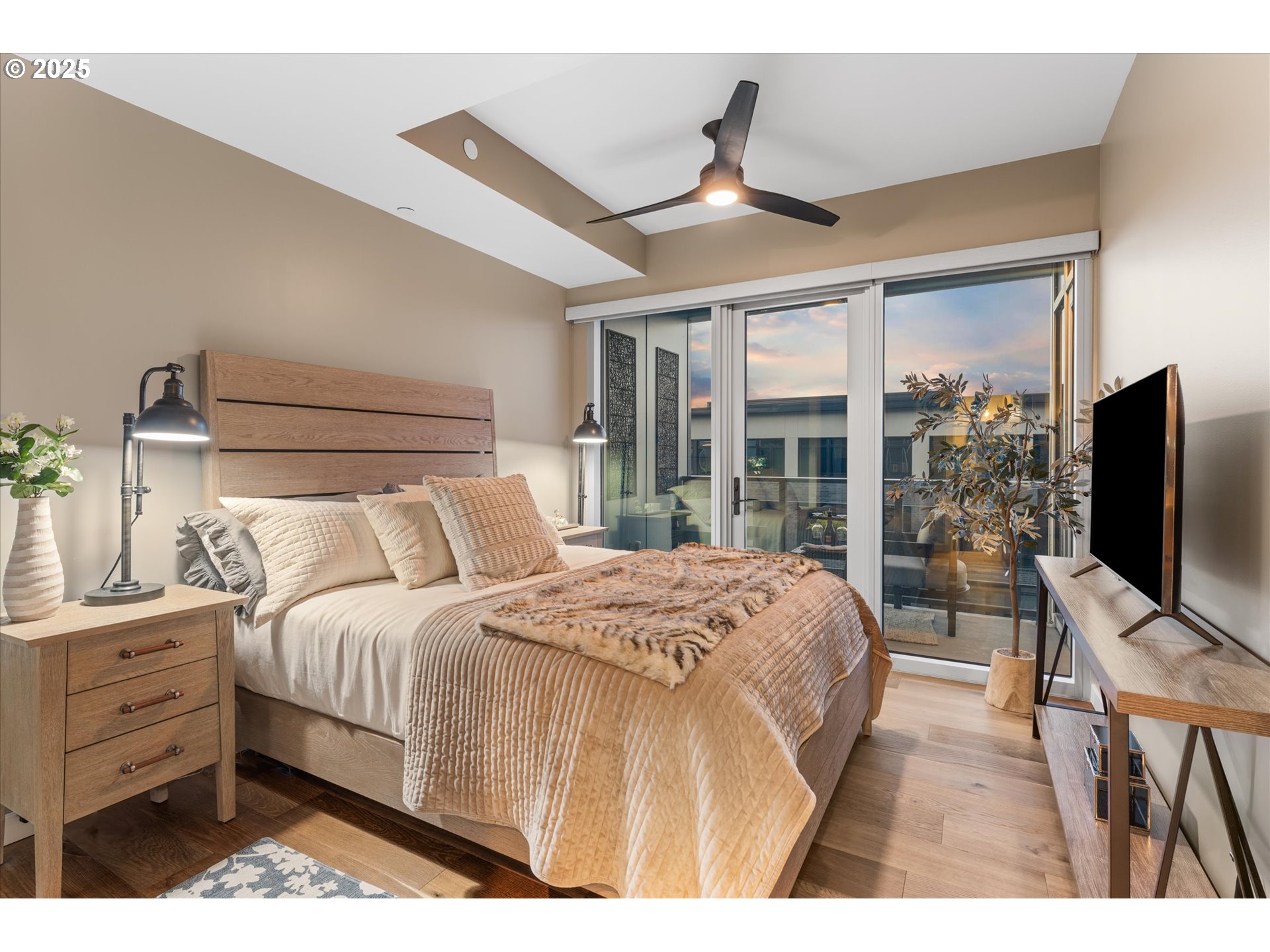 590 Waterfront Way, Unit 700 Vancouver, WA 98660 - Photo 15 of 35 a bedroom with a large bed and a flat tv screen on dresser