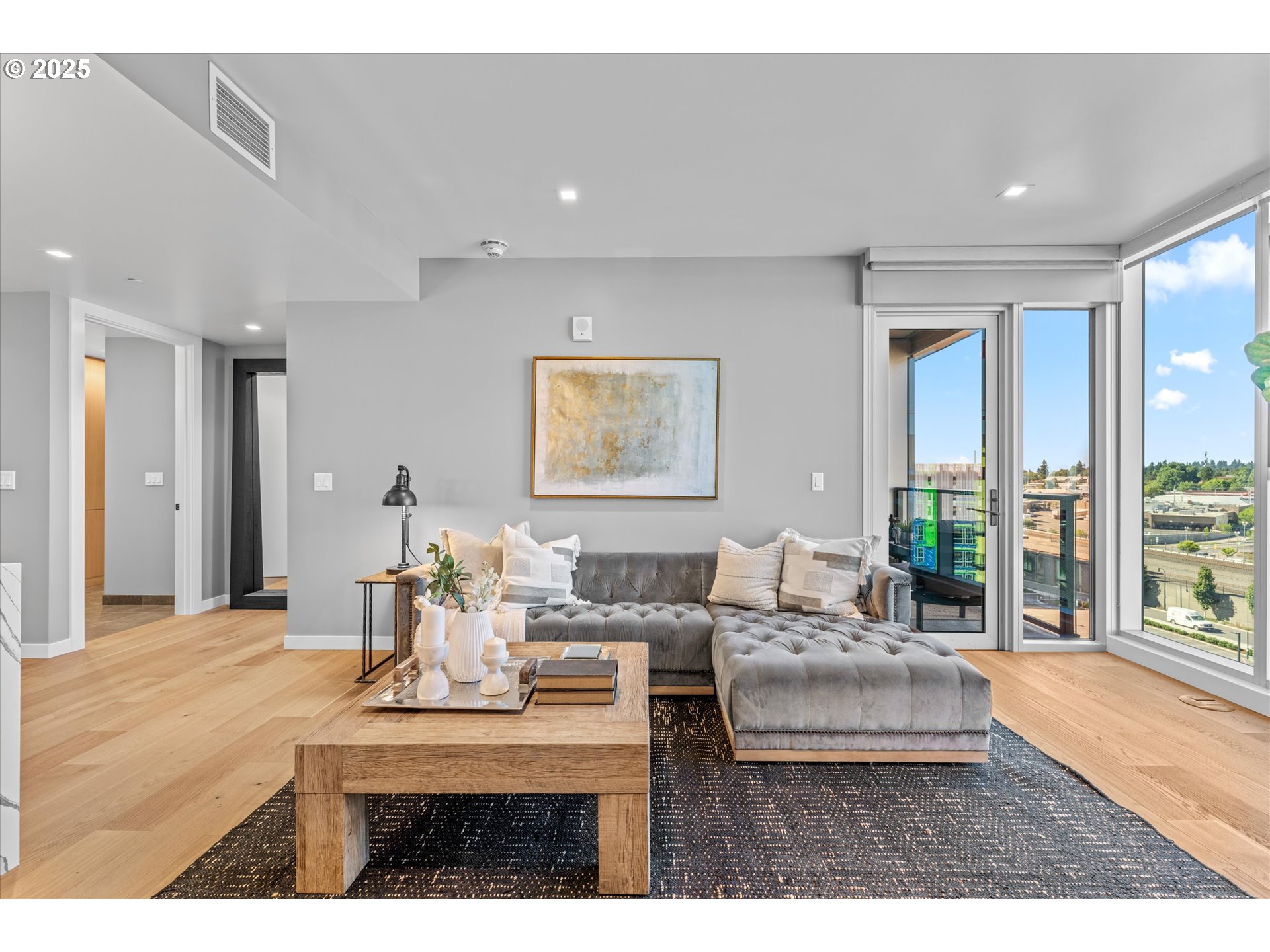 590 Waterfront Way, Unit 700 Vancouver, WA 98660 - Photo 16 of 35 a living room with furniture a large window and wooden floor