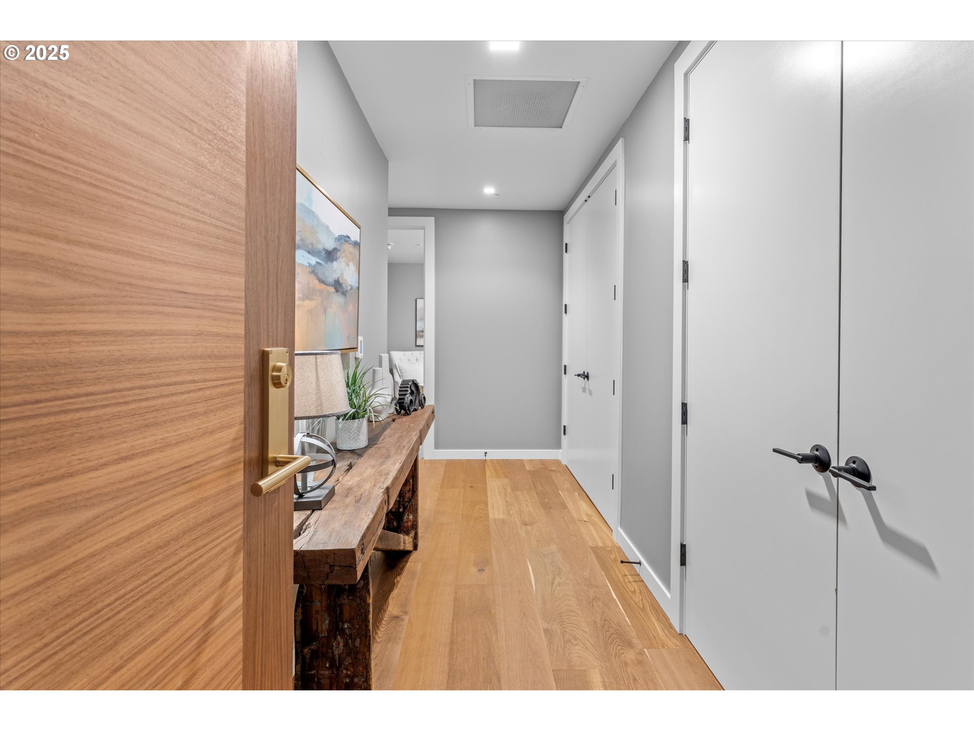 590 Waterfront Way, Unit 700 Vancouver, WA 98660 - Photo 2 of 35 a hallway with a wooden floor