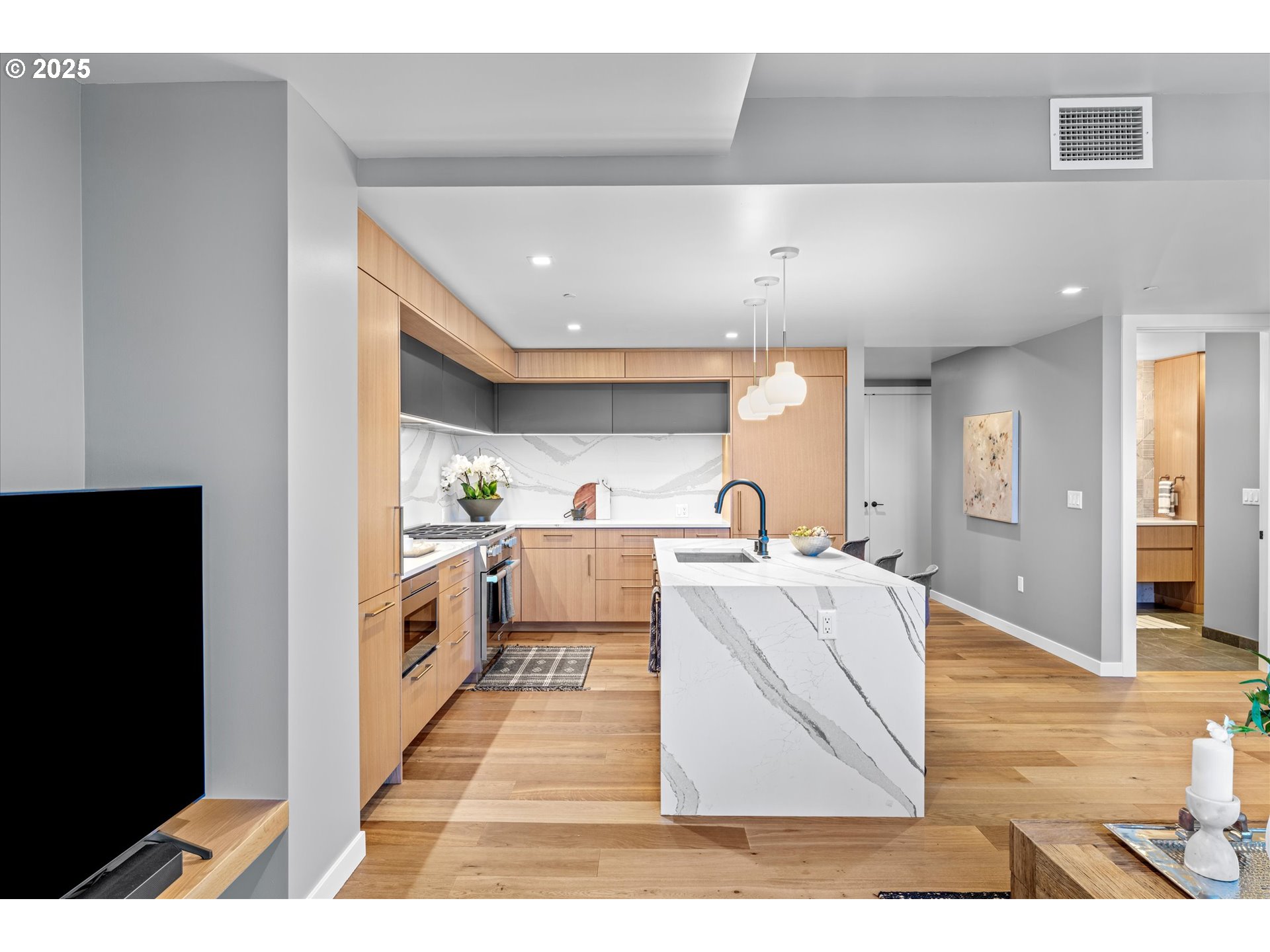 590 Waterfront Way, Unit 700 Vancouver, WA 98660 - Photo 6 of 35 a living room with stainless steel appliances kitchen island granite countertop furniture and a view of kitchen