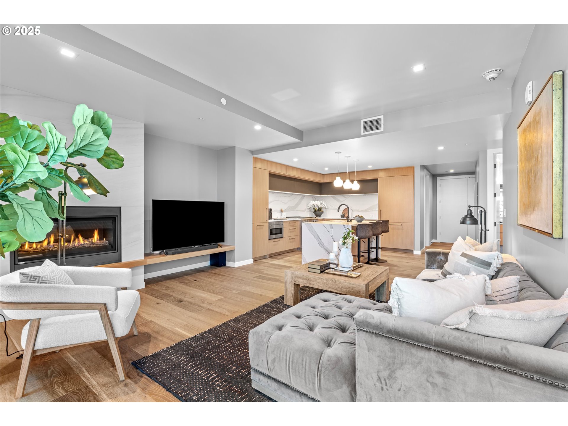 590 Waterfront Way, Unit 700 Vancouver, WA 98660 - Photo 9 of 35 a living room with furniture a flat screen tv and a fireplace