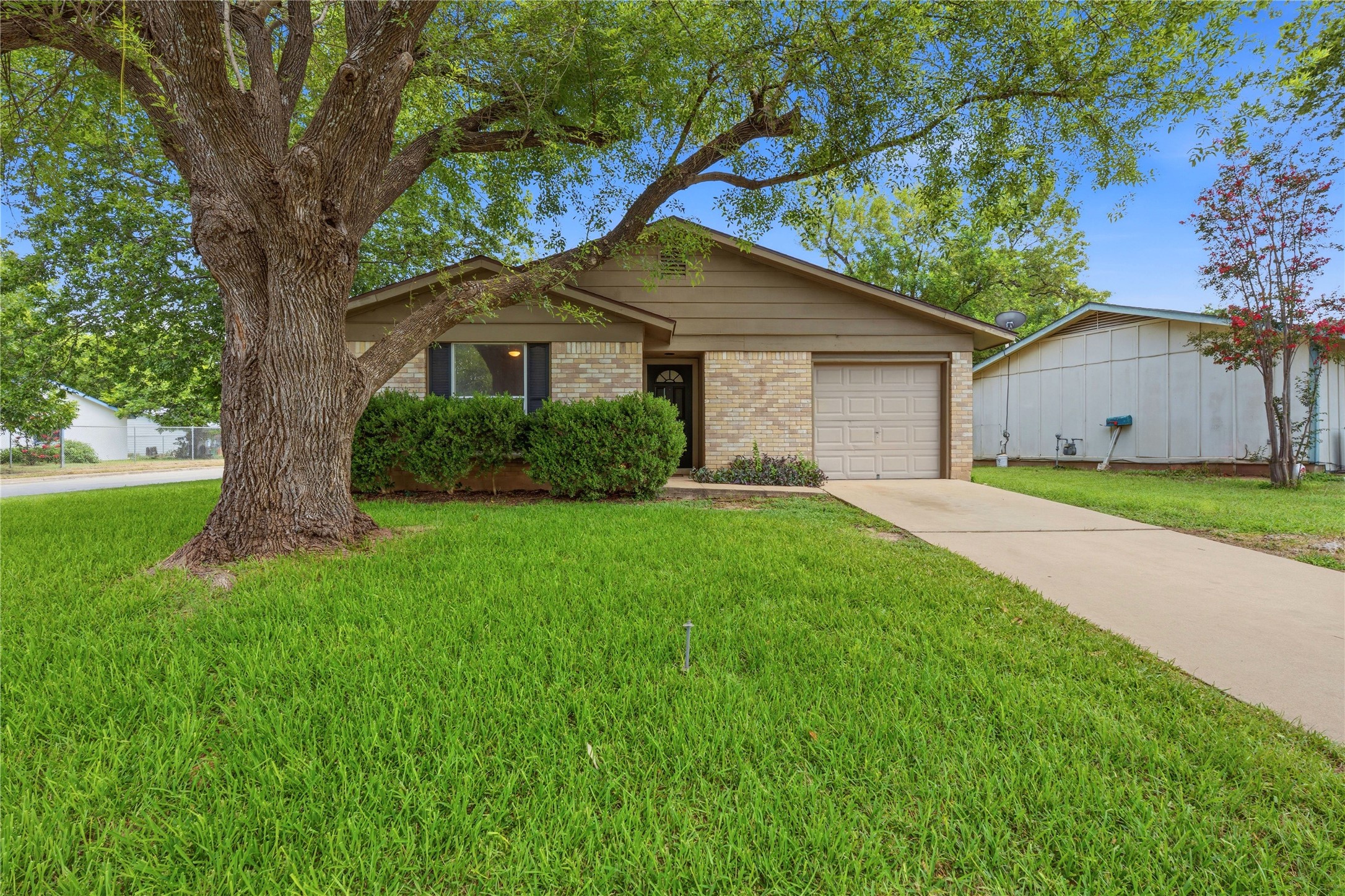 6205 Shadow Bend Austin, TX 78745 - Photo 5 of 31 A well-maintained lawn welcomes you to this inviting residence with an attached garage.