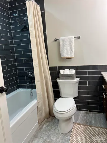 a bathroom with a toilet a sink and bathtub