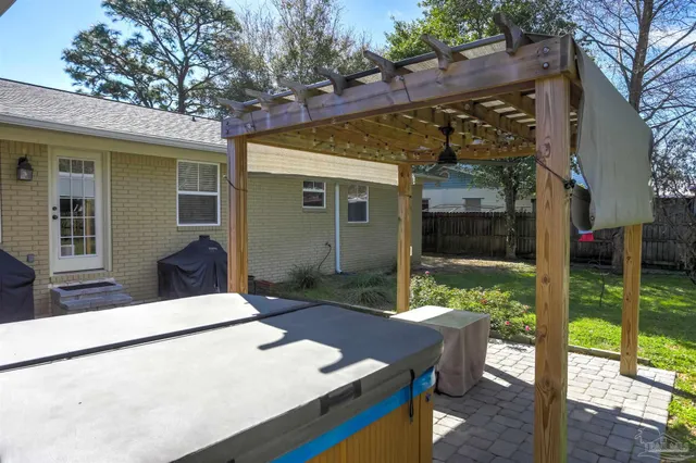 a view of a patio with table and chairs potted plants with wooden floor and fence