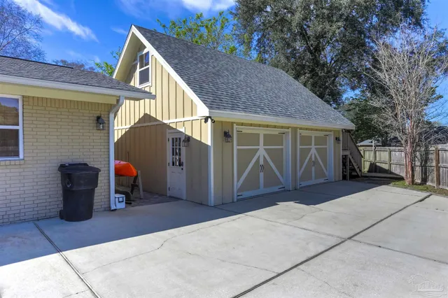 a view of a house with backyard and sitting area
