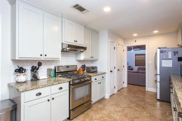a kitchen with a sink stove and refrigerator
