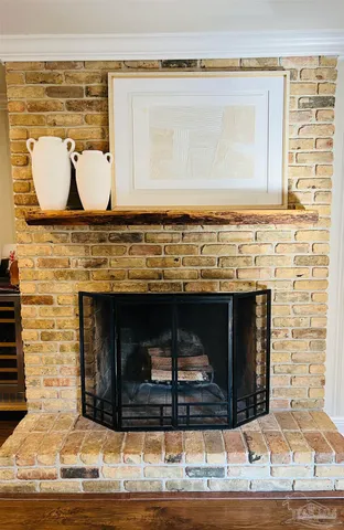 a living room with granite countertop a fireplace and a wooden floor