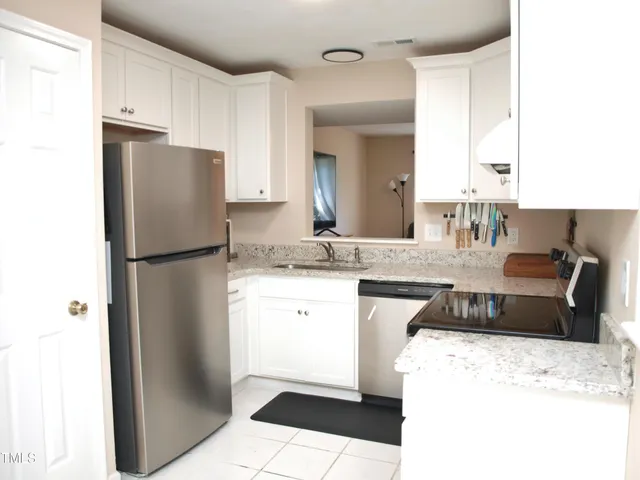 a kitchen with a refrigerator sink and stove