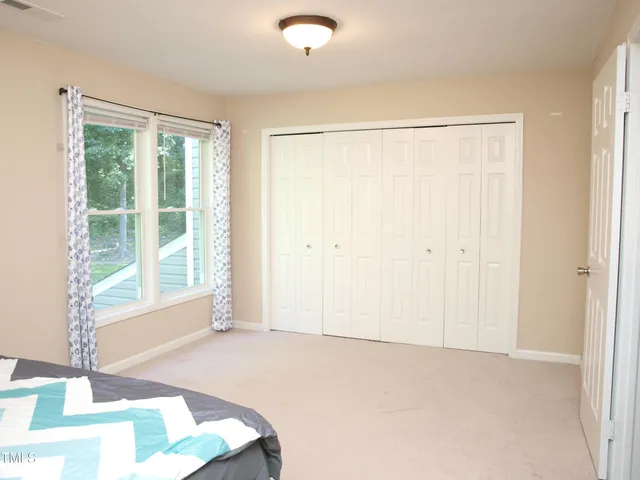 a bathroom with a granite countertop toilet sink and mirror