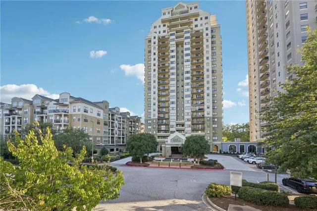a view of a hallway with furniture and wooden floor