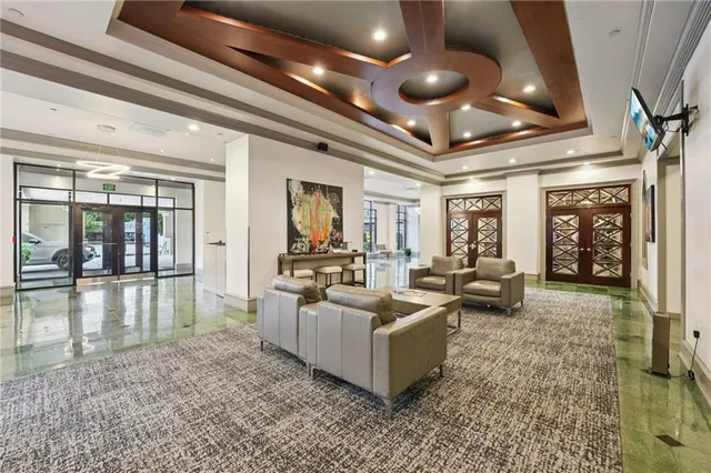 a lobby with furniture and floor to ceiling window