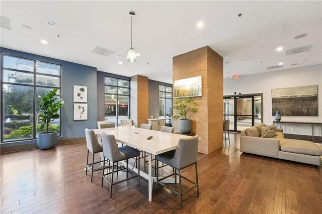 a dining room with stainless steel appliances kitchen island granite countertop a dining table chairs and view living room