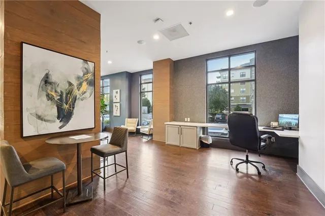 a kitchen with a stove a refrigerator and a living room view