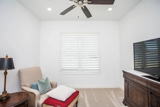 a bedroom with a bed and painting on the wall