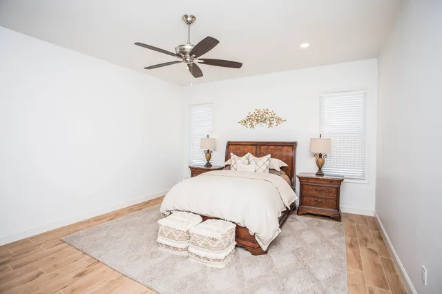 a spacious bathroom with double vanity a mirror and a shower