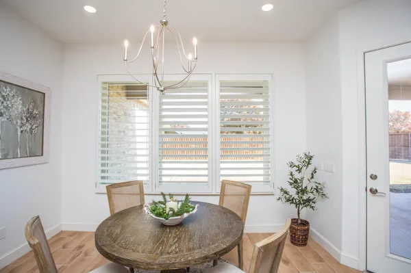a dining room with furniture and window