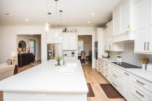 a large kitchen with kitchen island a sink stainless steel appliances and cabinets