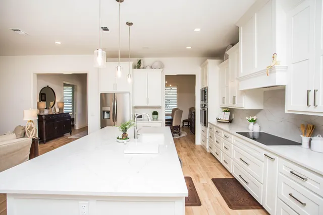 a large kitchen with kitchen island a sink stainless steel appliances and cabinets